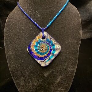 Vibrant Blue and Teal with swirls of gold and sliver.